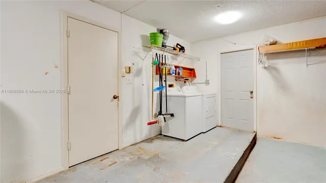a view of a storage & utility room with closet dryer and washer