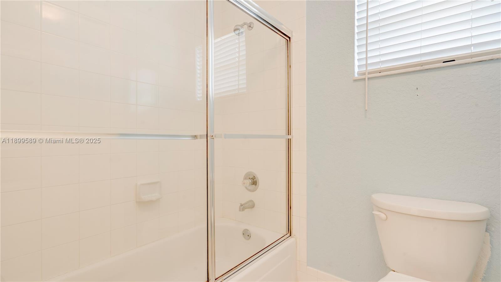 6255 Hawkes Bluff Avenue Davie, FL 33331 - Photo 36 of 51 a bathroom with a shower and a toilet