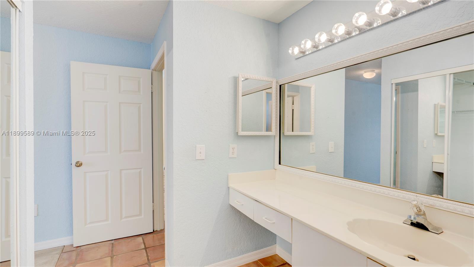 6255 Hawkes Bluff Avenue Davie, FL 33331 - Photo 37 of 51 a bathroom with a sink and a mirror