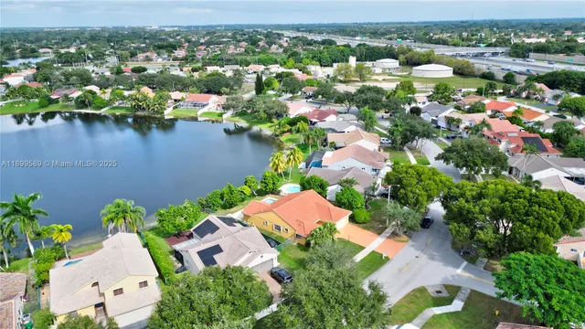 an aerial view of residential houses with outdoor space and swimming pool