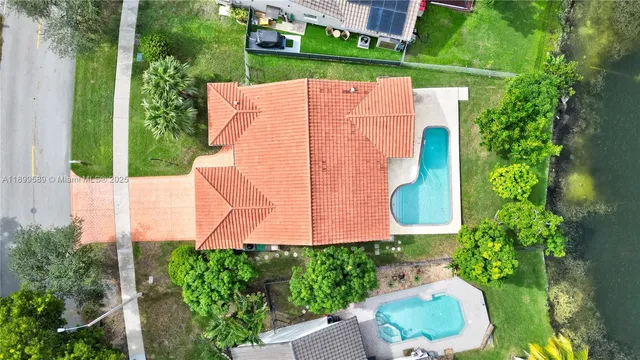 a aerial view of a house with a yard and potted plants