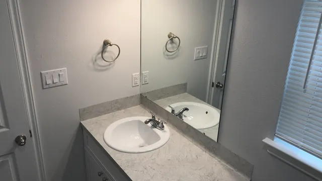 a bathroom with a tub sink and mirror