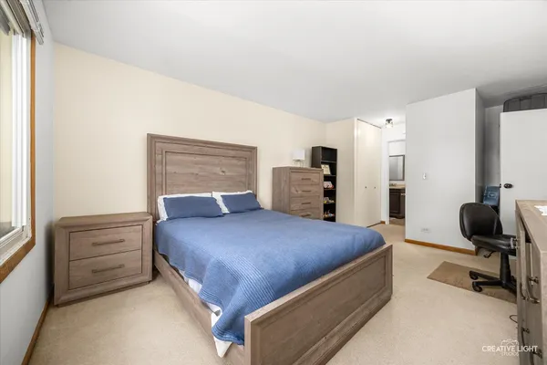 a bedroom with a bed a table and chair