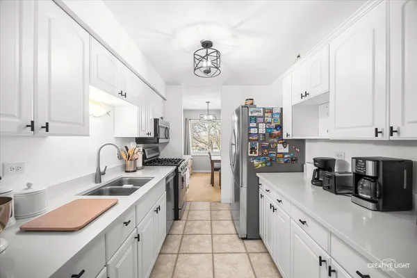 a kitchen with stainless steel appliances a sink a stove and a refrigerator