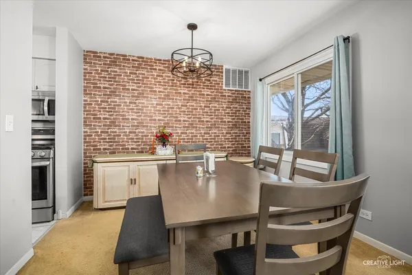 a dining room with furniture and window