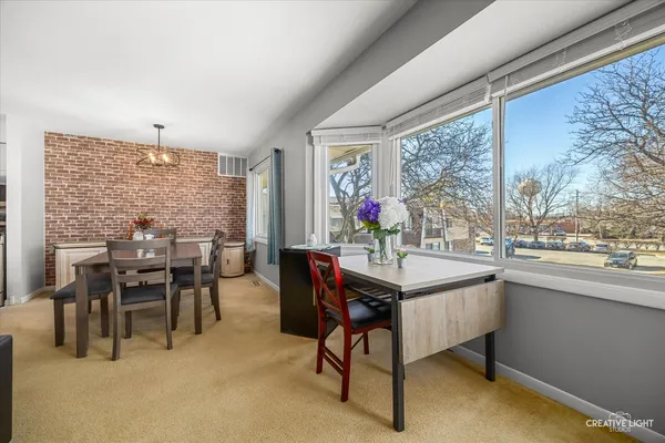 a view of a dining room with furniture window and outside view