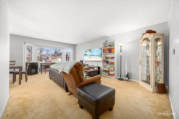 a bedroom with furniture and a large window