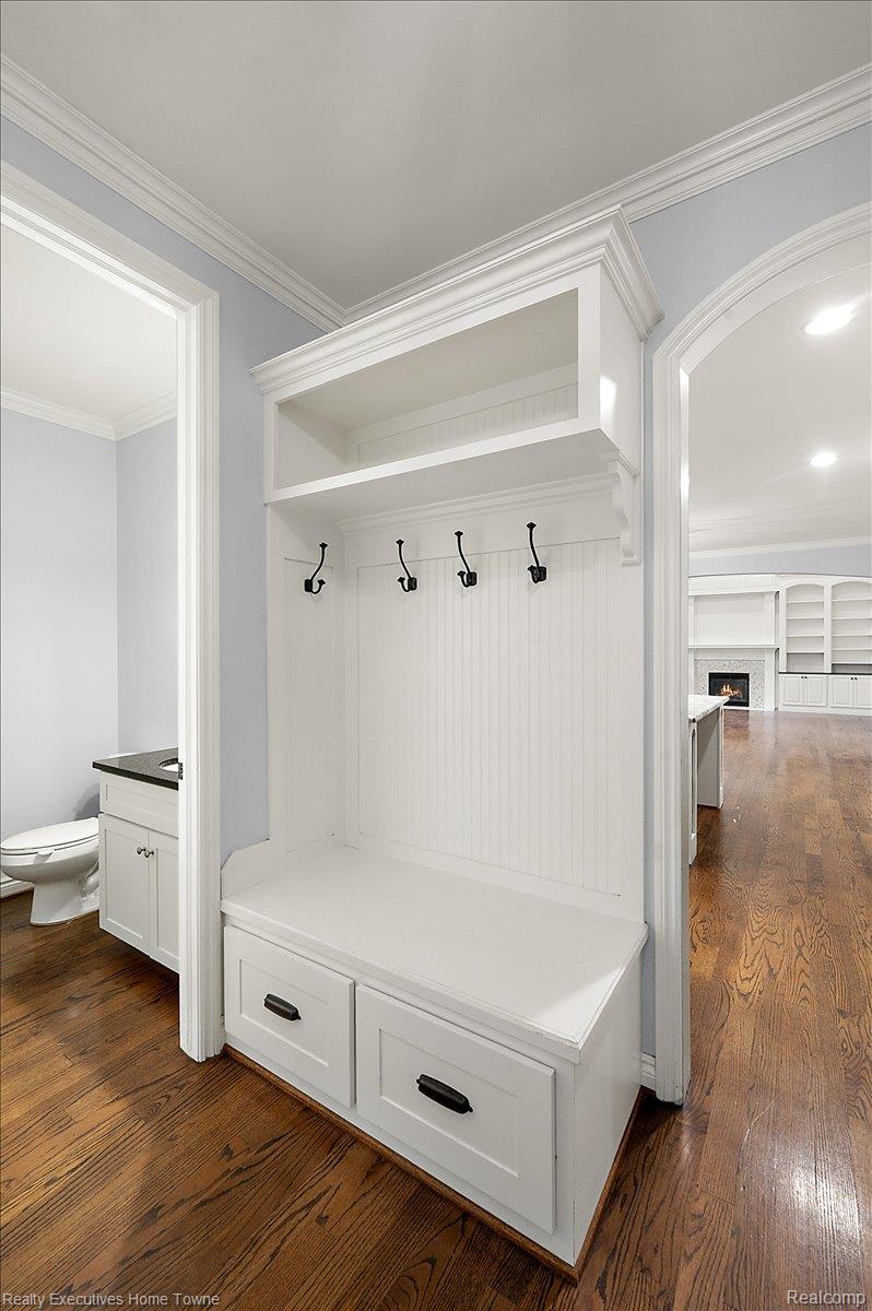 2919 North Addison Circle Rochester, MI 48306 - Photo 28 of 69 Elegant mudroom featuring built-in white cabinetry with lower storage drawers, a cushioned bench seat, and four hook wall-mounted coat hangers