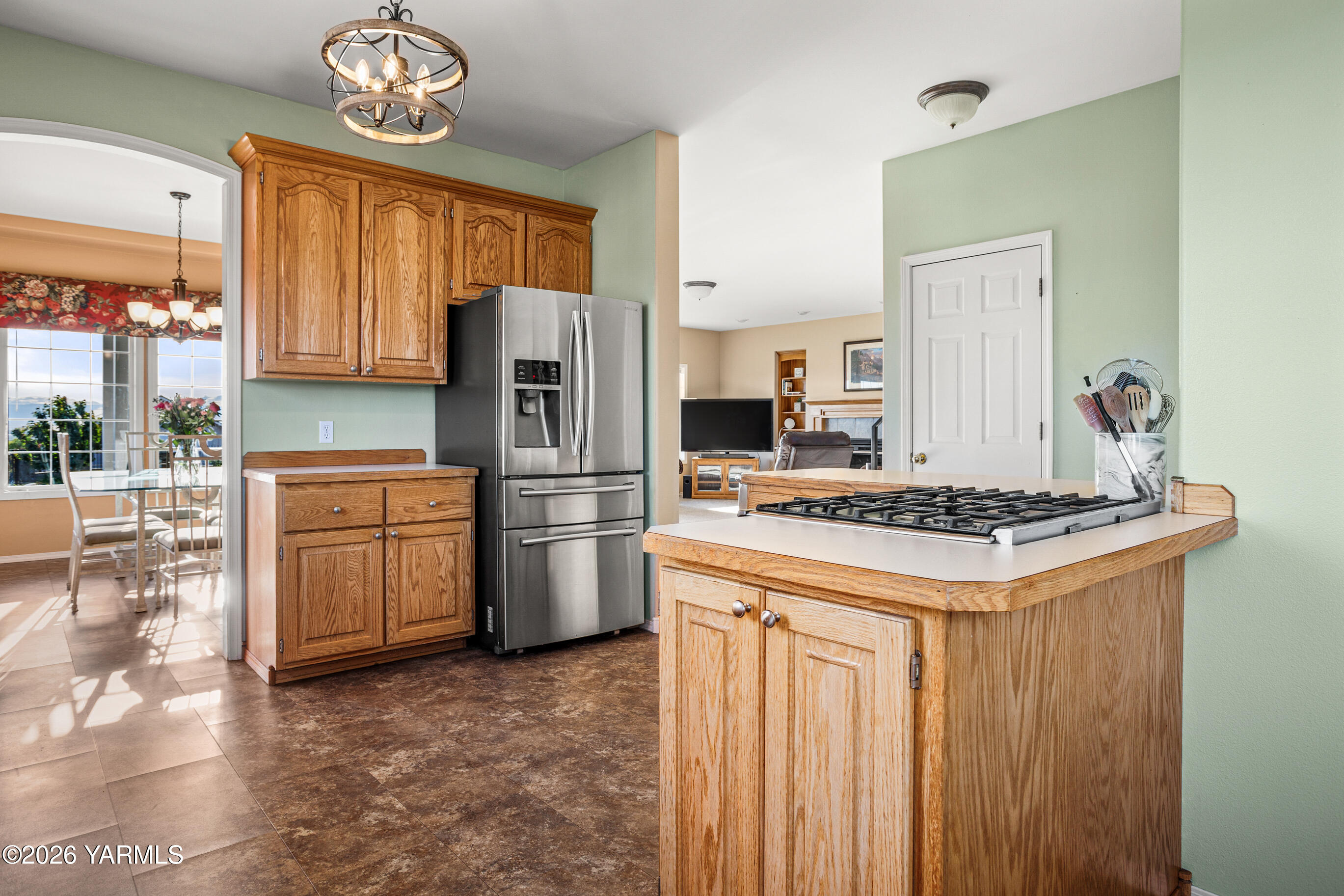 5060 Lombard Loop Road Zillah, WA 98953 - Photo 22 of 65 a kitchen with refrigerator a stove a sink dishwasher and wooden cabinets with wooden floor