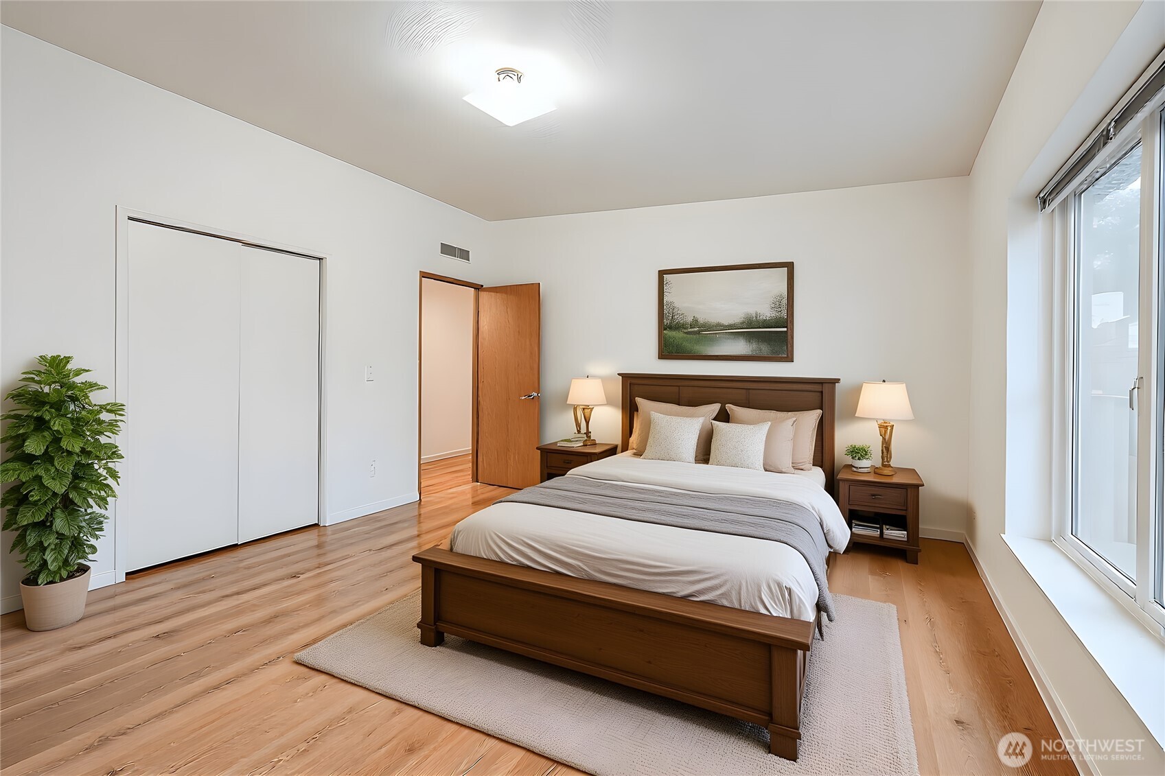 61 Flamingo Road Port Townsend, WA 98368 - Photo 13 of 22 a bedroom with a bed and a potted plant