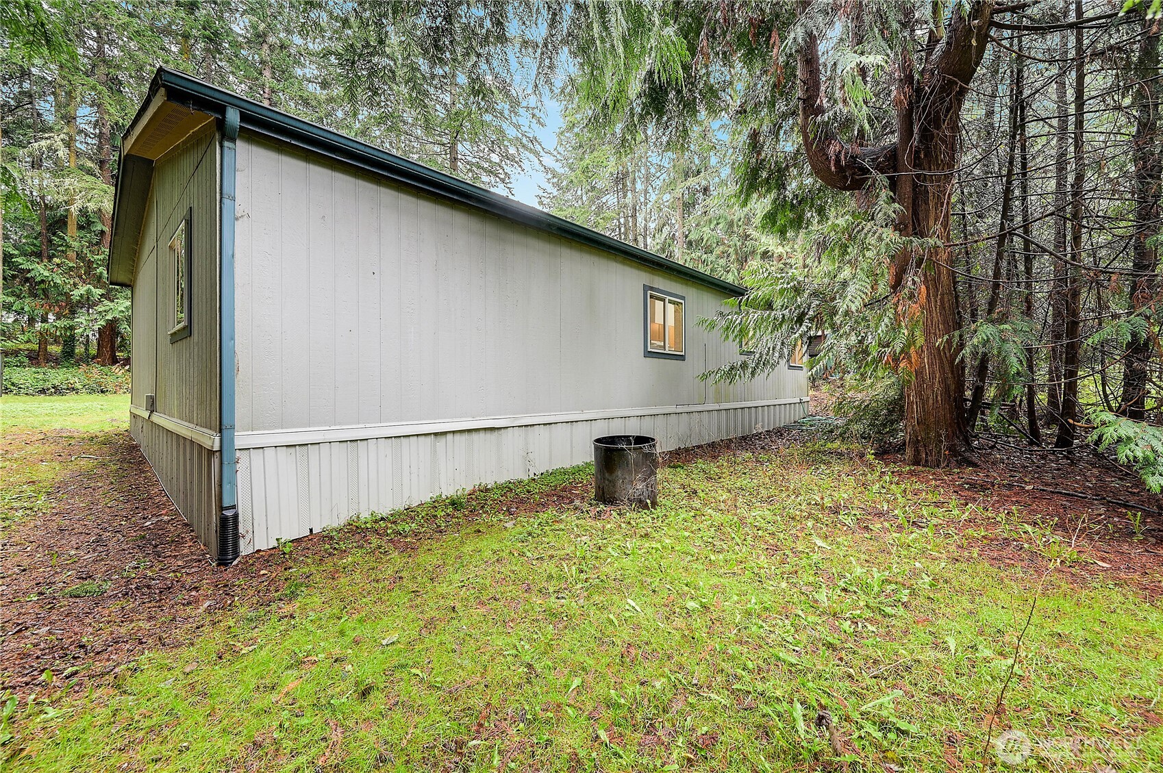 61 Flamingo Road Port Townsend, WA 98368 - Photo 22 of 22 a backyard of a house with lots of green space