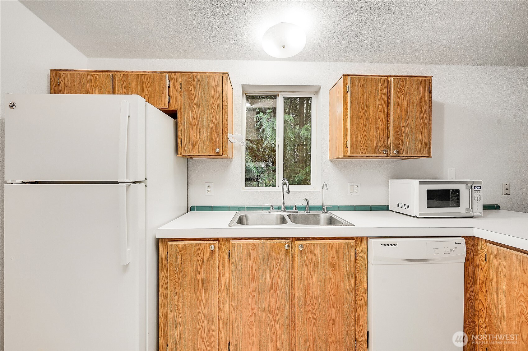 61 Flamingo Road Port Townsend, WA 98368 - Photo 8 of 22 a bathroom with a sink and a refrigerator
