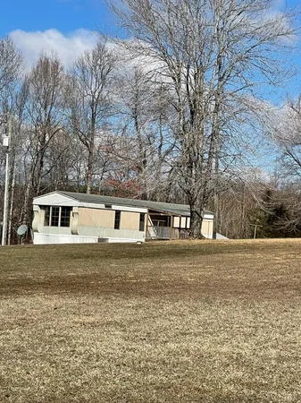 a front view of house with yard and trees