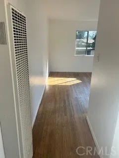 en empty room with wooden floor and window