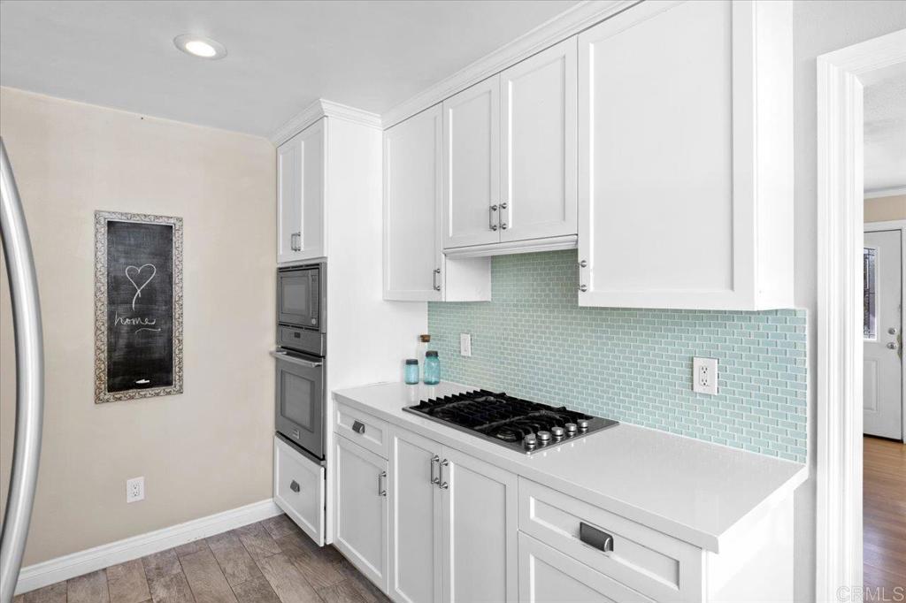 697 Ocean View Avenue Encinitas, CA 92024 - Photo 16 of 41 a kitchen with stainless steel appliances white cabinets and a sink
