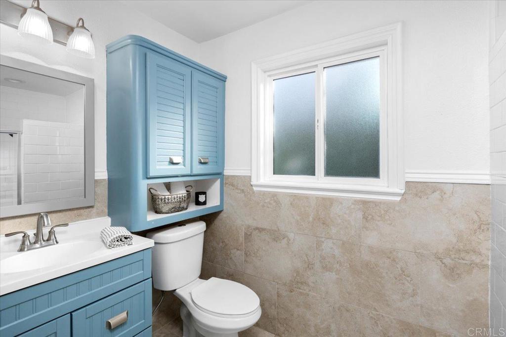 697 Ocean View Avenue Encinitas, CA 92024 - Photo 27 of 41 a bathroom with a toilet a sink and mirror