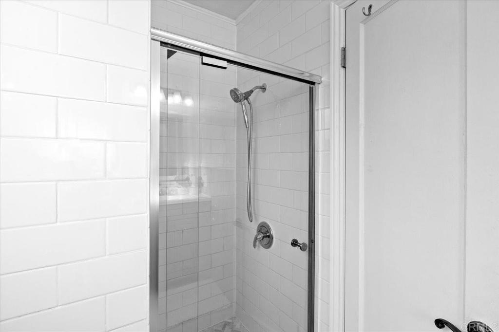 697 Ocean View Avenue Encinitas, CA 92024 - Photo 28 of 41 a bathroom with a glass shower door
