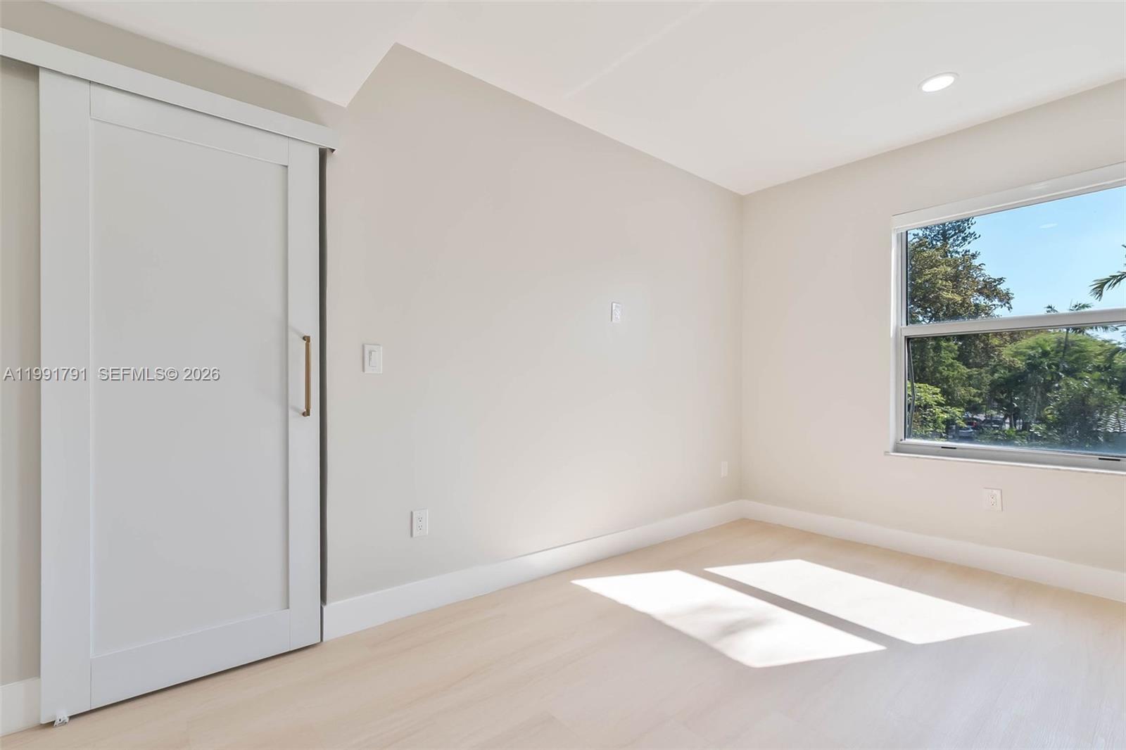 694 Northeast 76th Street, Unit 6 Miami, FL 33138 - Photo 12 of 35 an empty room with a window