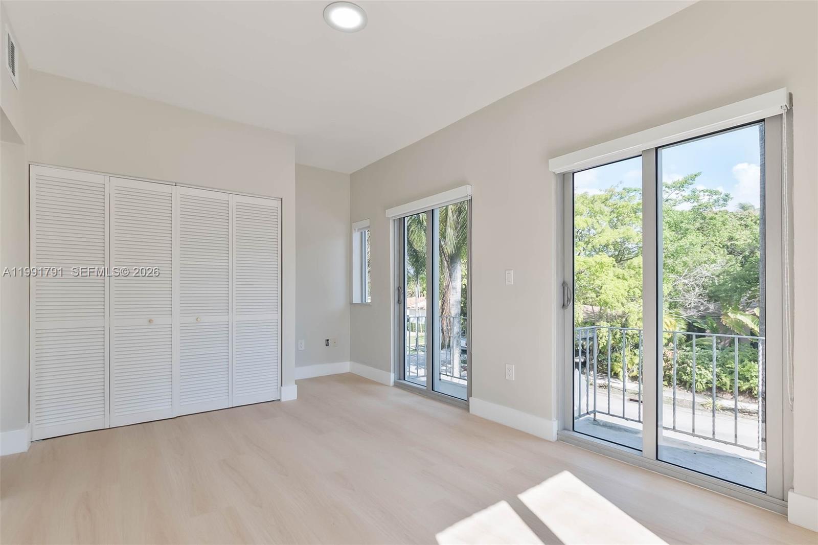 694 Northeast 76th Street, Unit 6 Miami, FL 33138 - Photo 14 of 35 a view of empty room with floor to ceiling window