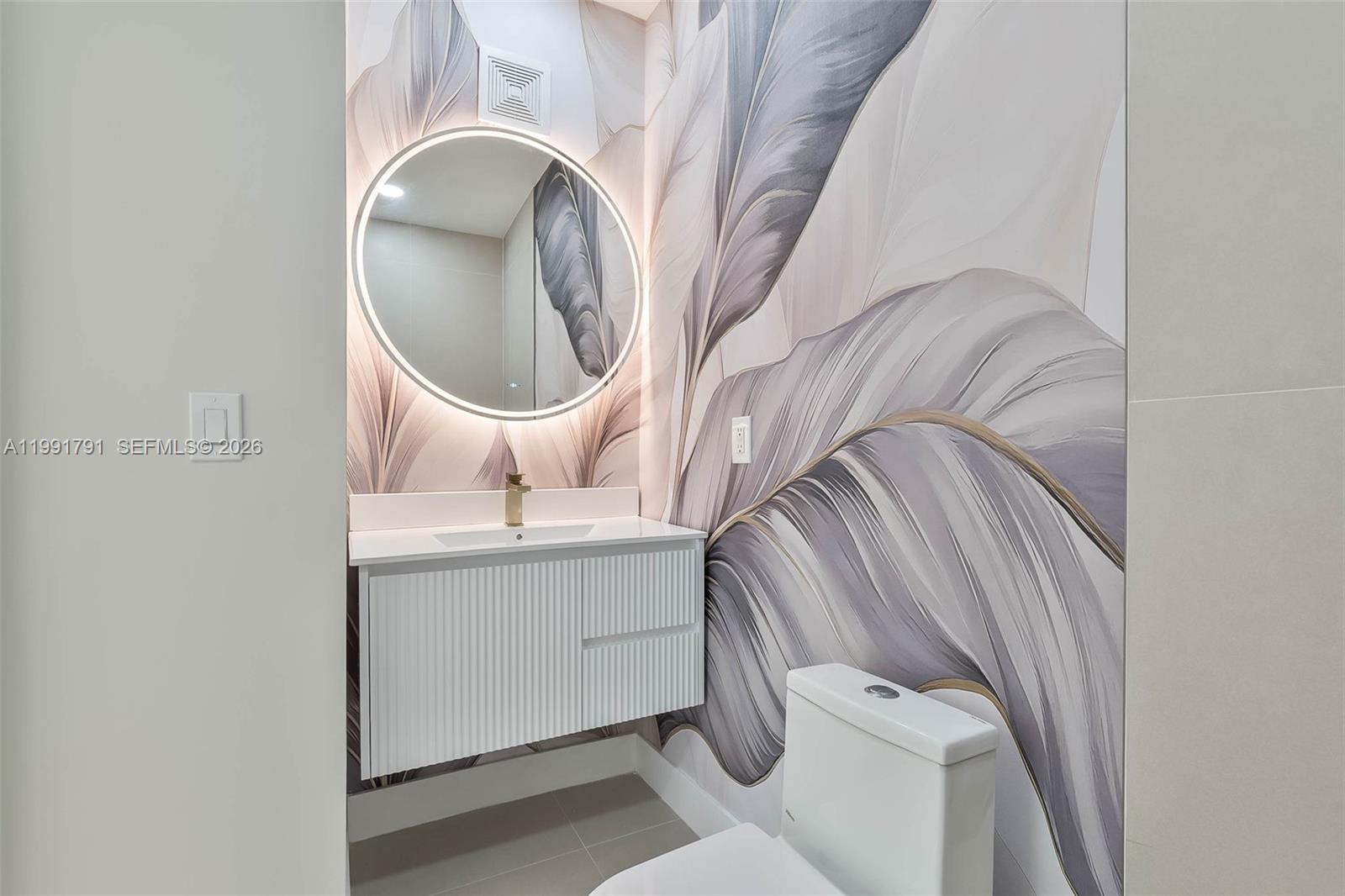 694 Northeast 76th Street, Unit 6 Miami, FL 33138 - Photo 19 of 35 a bathroom with a sink and a mirror