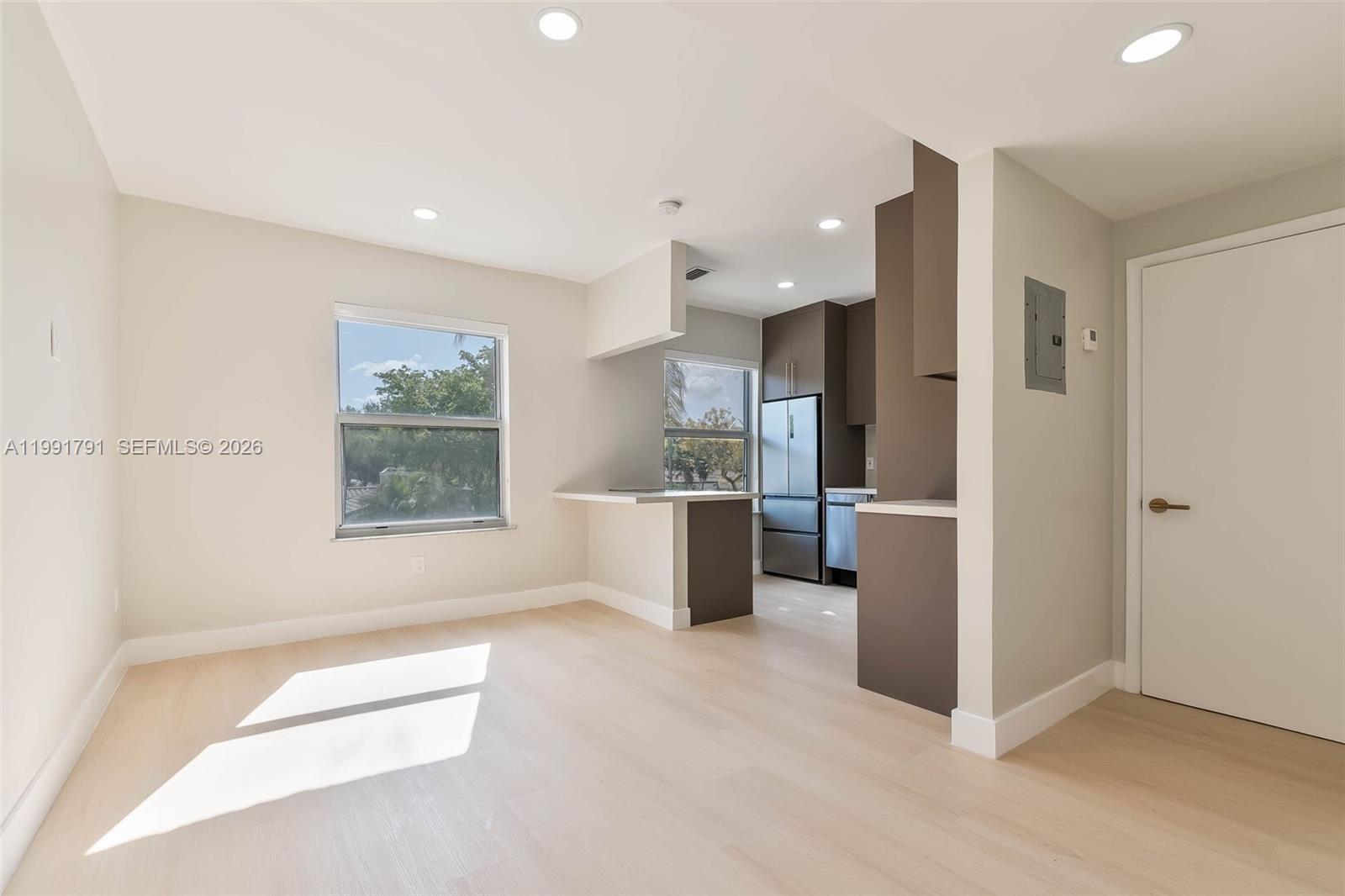 694 Northeast 76th Street, Unit 6 Miami, FL 33138 - Photo 2 of 35 a view of a kitchen with a sink and a refrigerator