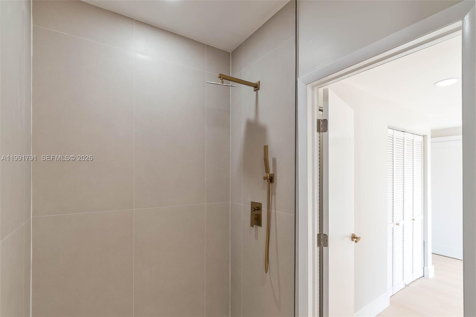 694 Northeast 76th Street, Unit 6 Miami, FL 33138 - Photo 21 of 35 a bathroom with a shower and a glass door