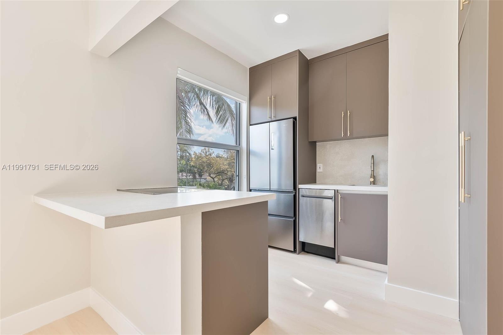 694 Northeast 76th Street, Unit 6 Miami, FL 33138 - Photo 3 of 35 a kitchen with a sink stove and refrigerator