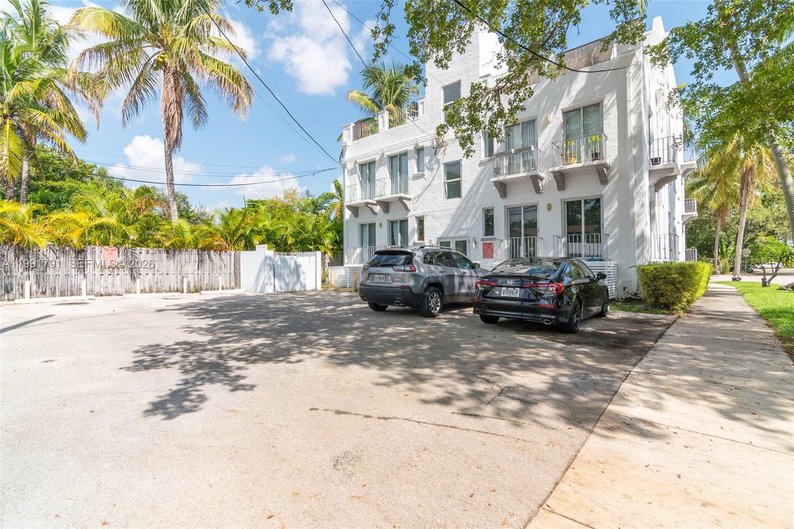694 Northeast 76th Street, Unit 6 Miami, FL 33138 - Photo 32 of 35 a view of a street with a cars parked in front of it