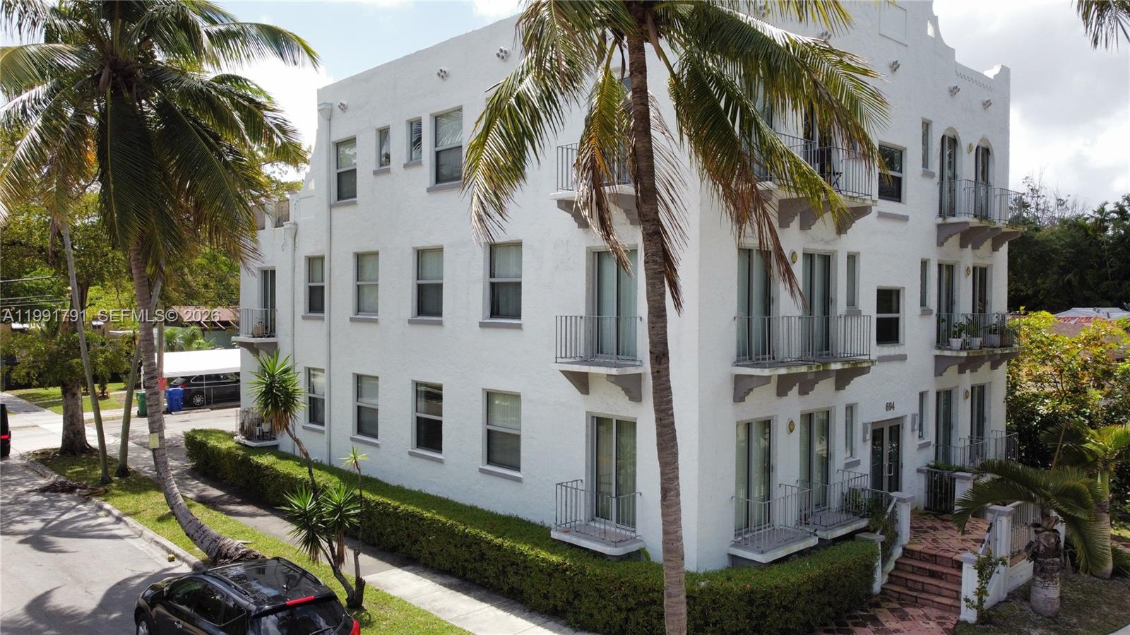 694 Northeast 76th Street, Unit 6 Miami, FL 33138 - Photo 35 of 35 a view of a building with a yard and many windows