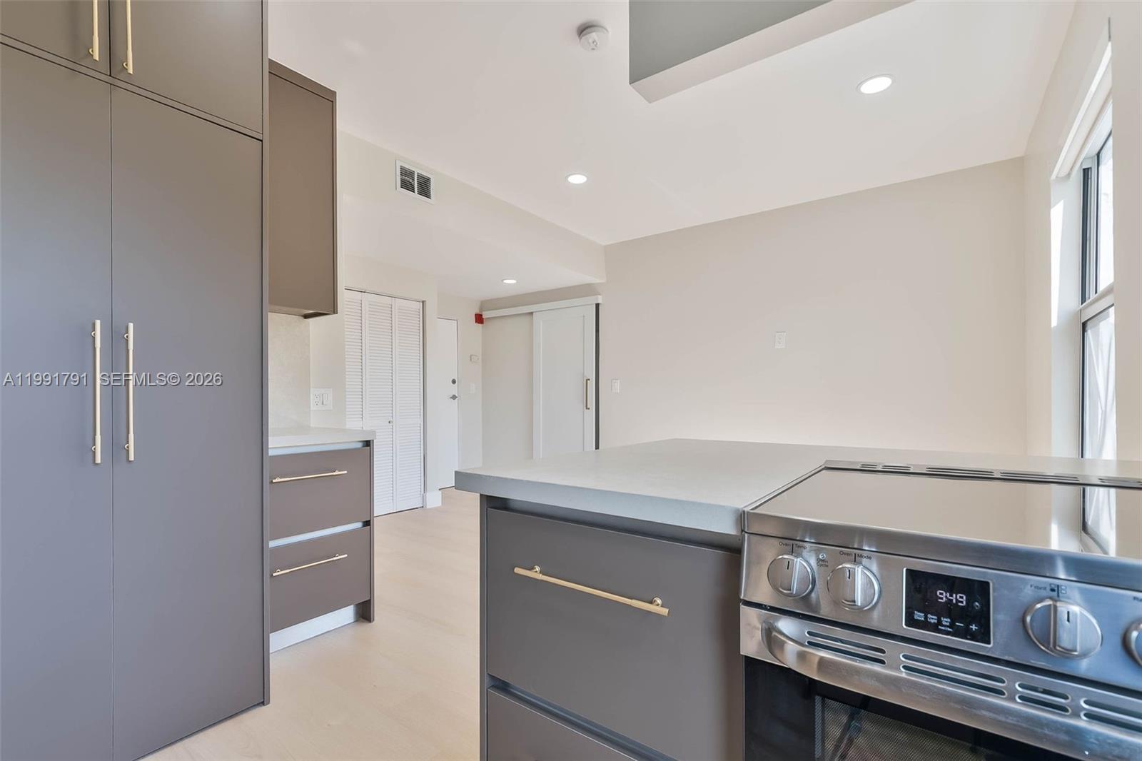 694 Northeast 76th Street, Unit 6 Miami, FL 33138 - Photo 7 of 35 a kitchen with stainless steel appliances a refrigerator and a stove