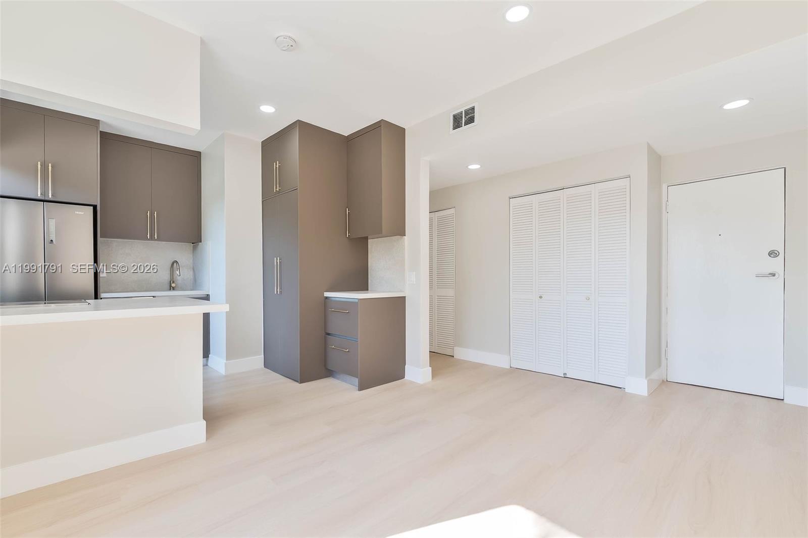 694 Northeast 76th Street, Unit 6 Miami, FL 33138 - Photo 9 of 35 a view of a kitchen with a refrigerator a sink and a refrigerator