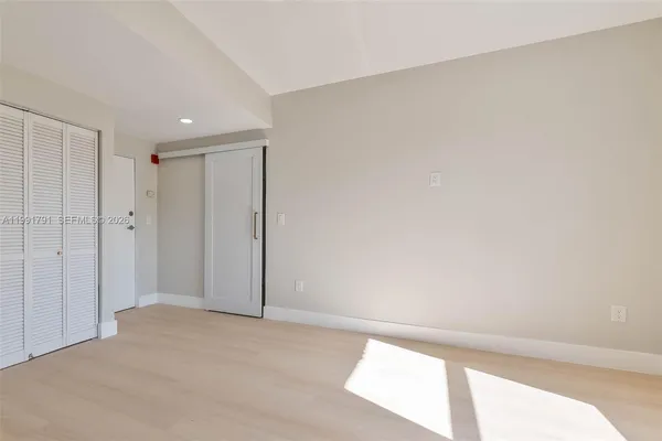 a view of a street with a cars parked in front of it