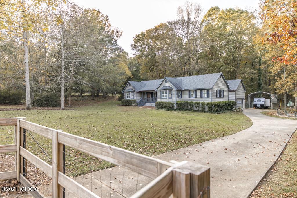 a view of house with outdoor space and sitting area