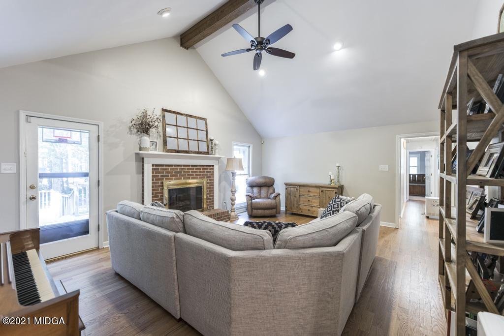 7085 Colaparchee Road Macon, GA 31220 - Photo 25 of 57 a living room with furniture a fireplace and a flat screen tv