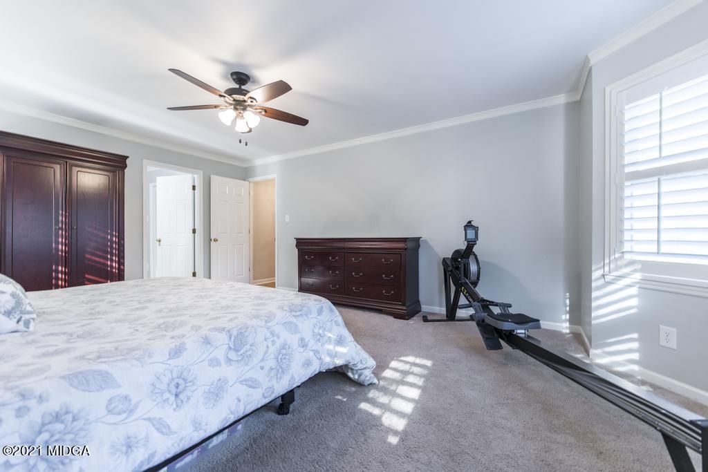 7085 Colaparchee Road Macon, GA 31220 - Photo 28 of 57 a bedroom with a bed and a chandelier