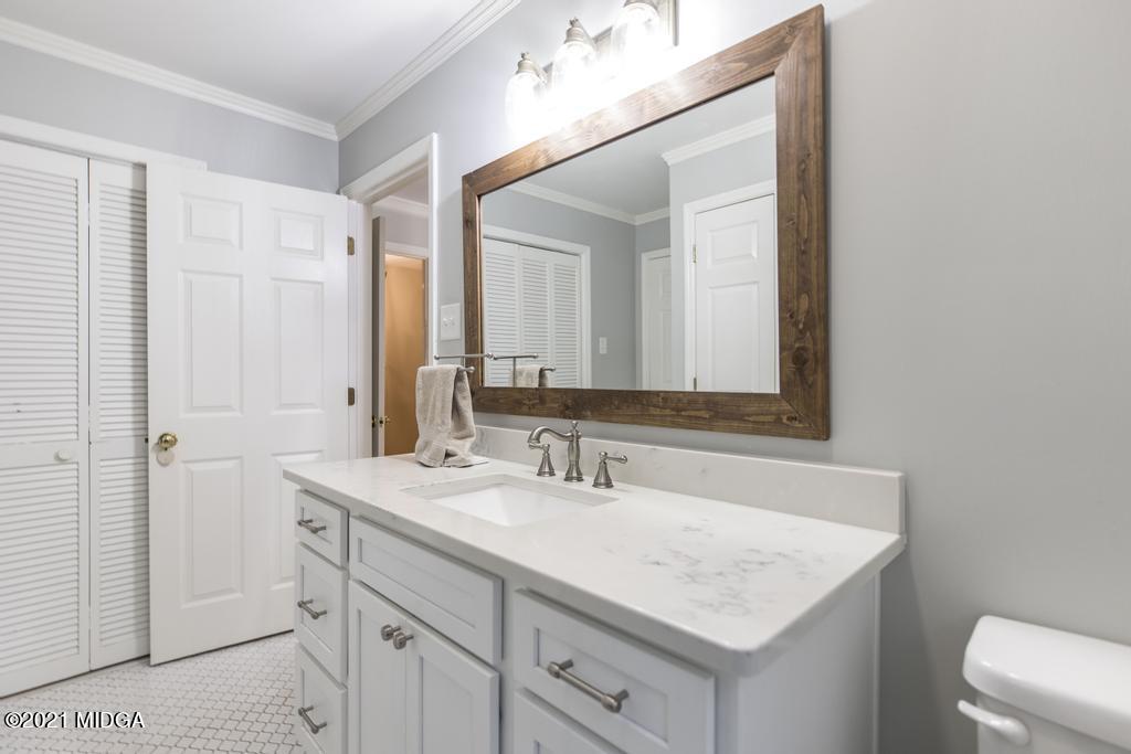 7085 Colaparchee Road Macon, GA 31220 - Photo 31 of 57 a bathroom with a sink vanity and a mirror