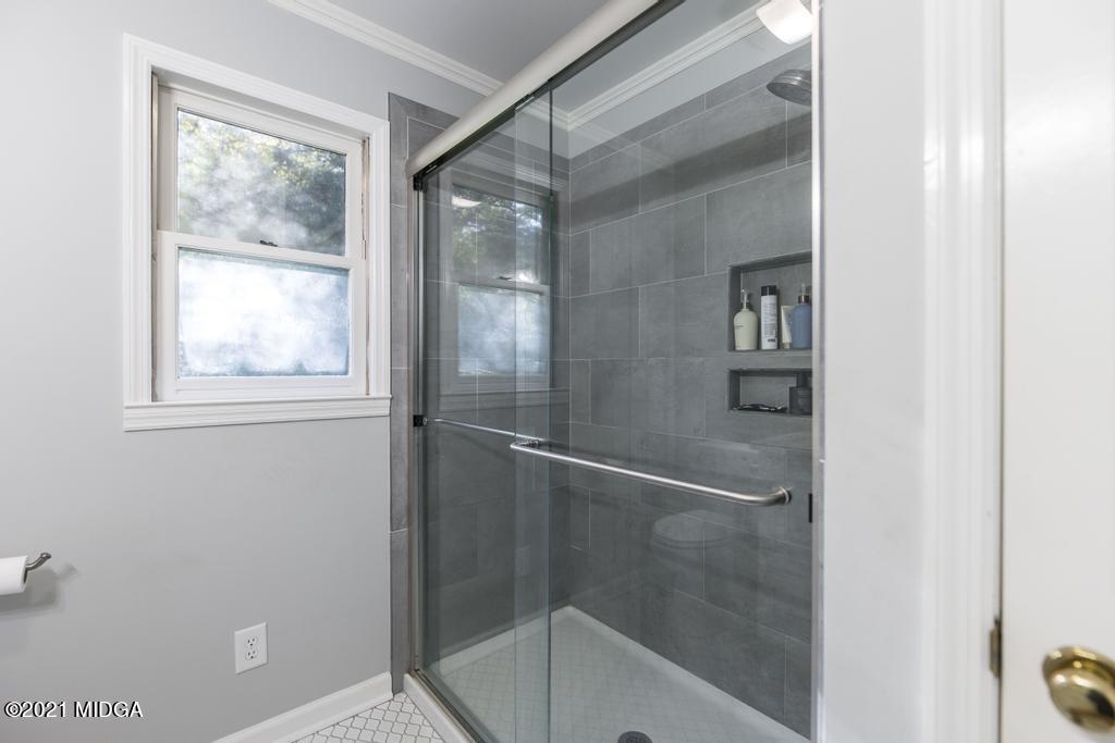 7085 Colaparchee Road Macon, GA 31220 - Photo 32 of 57 a bathroom with a glass shower door