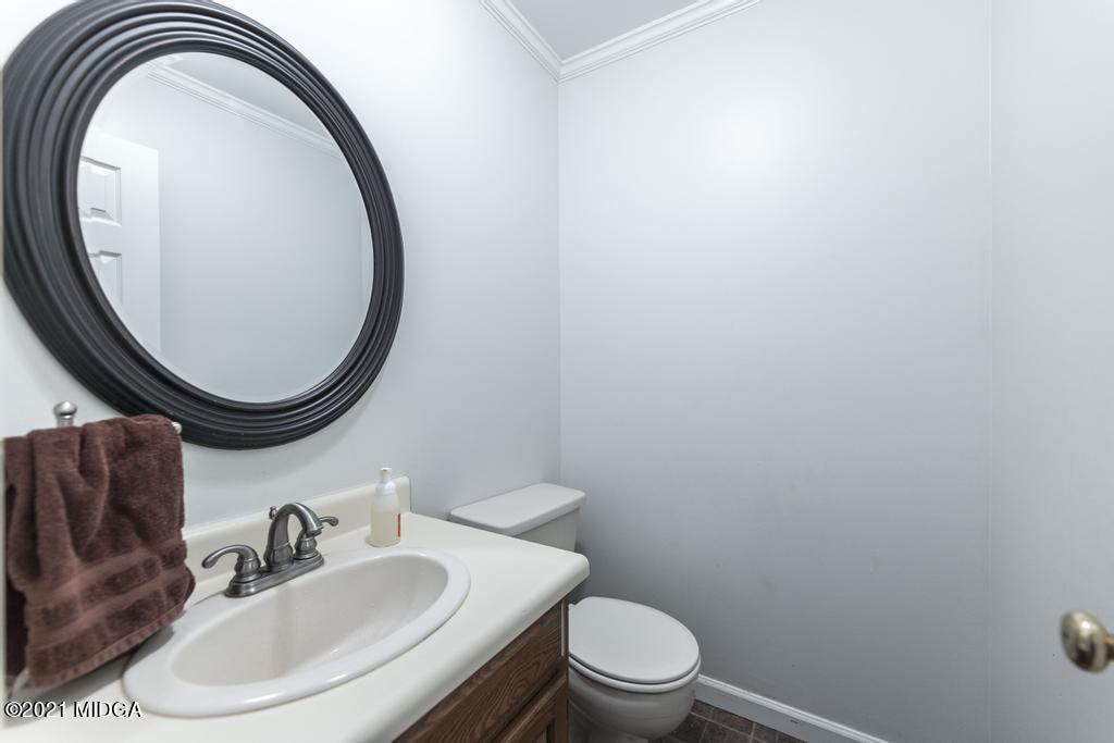 7085 Colaparchee Road Macon, GA 31220 - Photo 34 of 57 a bathroom with a sink and a mirror