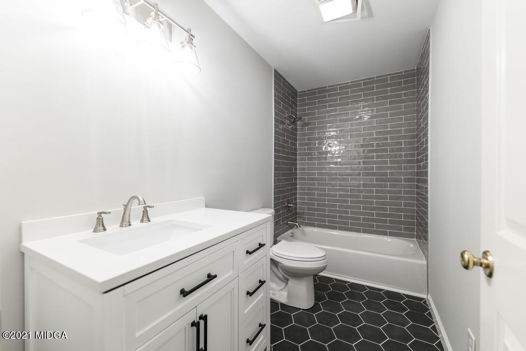 7085 Colaparchee Road Macon, GA 31220 - Photo 37 of 57 a bathroom with a sink a toilet and shower