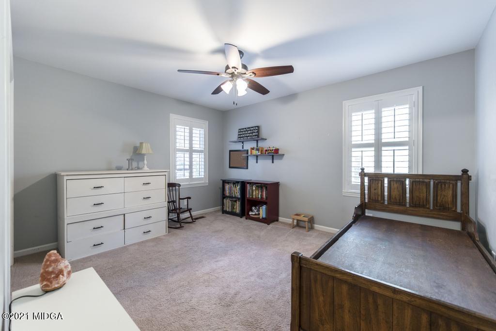 7085 Colaparchee Road Macon, GA 31220 - Photo 38 of 57 a view of a bedroom with furniture and a ceiling fan