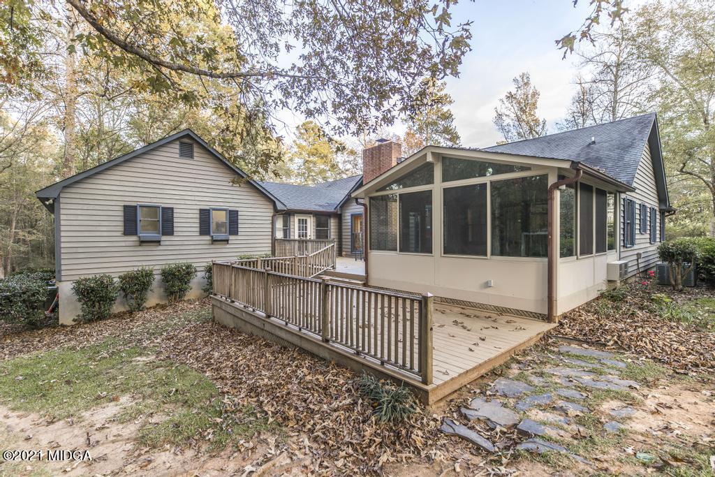 7085 Colaparchee Road Macon, GA 31220 - Photo 50 of 57 a view of a house with a small yard and large trees