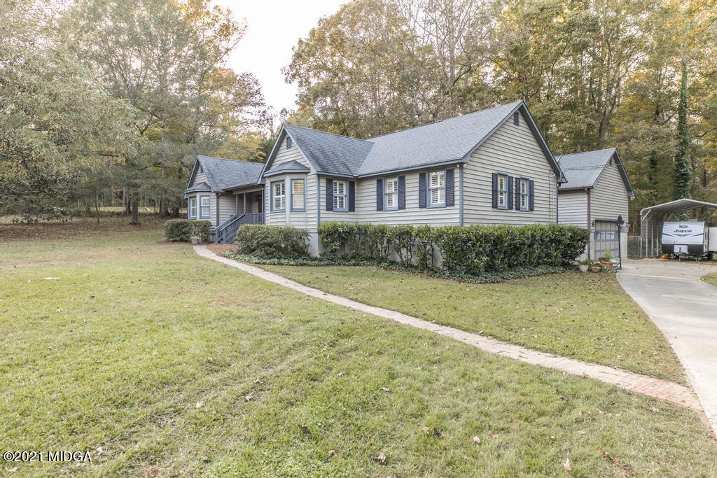 7085 Colaparchee Road Macon, GA 31220 - Photo 8 of 57 a front view of a house with a garden