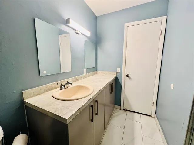 a view of a room with a ceiling fan and wooden floor