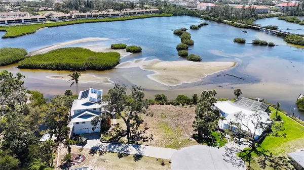 an aerial view of a house with a garden and lake view