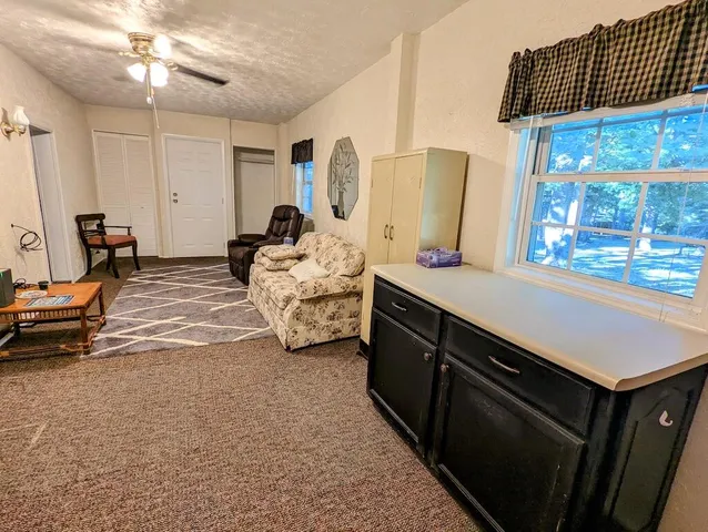 a bedroom with furniture and a window