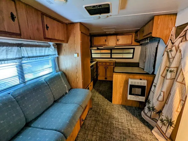 a view of living room with furniture and a fireplace