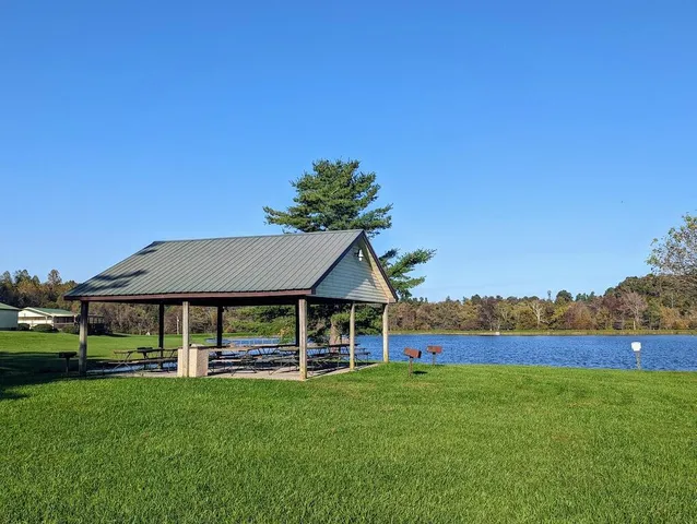 a view of a house with a yard and sitting area