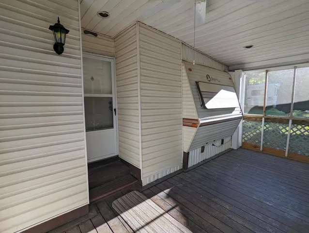 a view of a balcony with wooden door