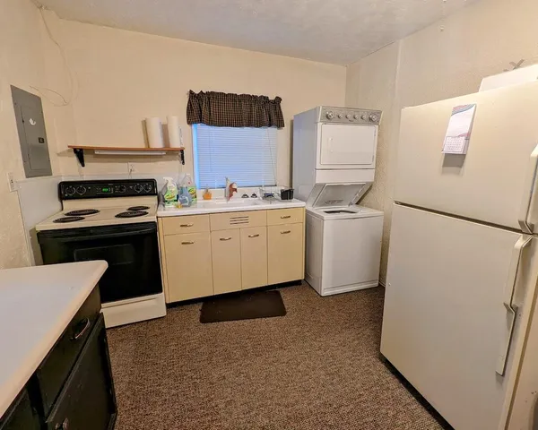 a kitchen with a refrigerator sink and stove
