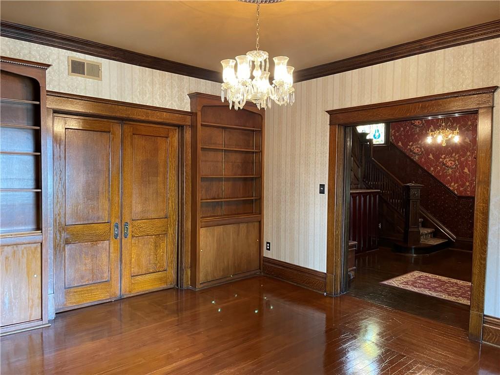 244 West Pearl Street Butler, PA 16001 - Photo 8 of 25 an empty room with wooden floor chandelier and windows